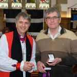 Bishop Hugh presenting cross to Richard Margetts